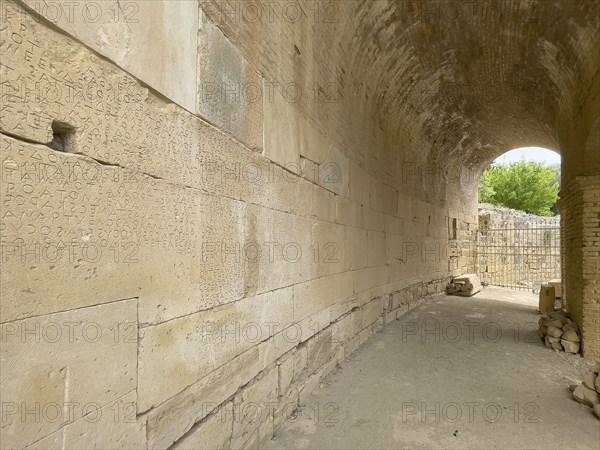 Wall of archway behind amphitheatre carved written chiselled laws City law of Gortys carved in stone Gortyn law book Large inscription, written in Doric dialect alternately from left to right and right to left, oldest discovered legal text in Europe, Gortyna, Crete, Greece, Europe