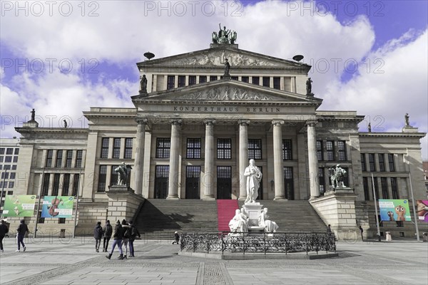 The concert hall am Gendarmenmarkt in Berlin, Germany, Europe, Historic building with columns and stairs, people in the foreground and blue sky, Berlin, Europe