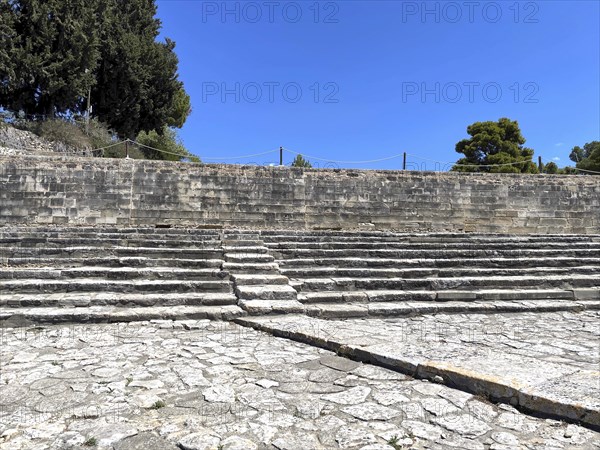 Ancient theatre tiers Seats for spectators Theatre visitors in the middle Staircase of historic ancient open-air theatre Open-air theatre in upper part of palace hill Hill of Phaistos, Festos, Crete, Greece, Europe