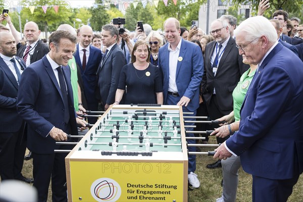 Emmanuel Macron (President of the French Republic) and Frank-Walter Steinmeier (President of the Federal Republic of Germany) play table football during a tour of the Citizens' Festival celebrating democracy. / The Basic Law turns 75, together it will be a celebration, Berlin, 26.05.2024