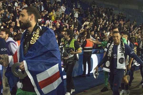 Football match, captain Kylian MBAPPE' Paris St. Germain proudly after the award ceremony with his personal championship trophy in miniature, lap of honour in the fan curve, Gianluigi DONNARUMMA Paris St. Germain in front, Parc des Princes football stadium, Paris, France, Europe