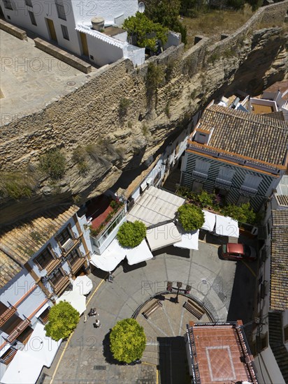 Aerial view of a Spanish village with narrow streets and stone wall, surrounded by buildings and trees in summer, aerial view, cave dwellings, Setenil de las Bodegas, Cadiz, Andalusia, Spain, Europe