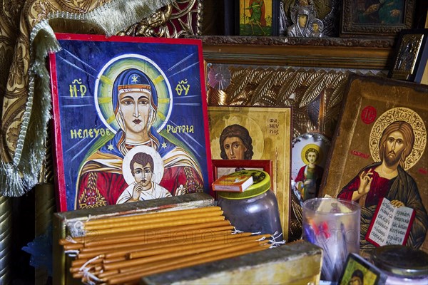 Rock chapel, Archangel Michael Panormitits, icons and religious objects on a devotional altar, illuminated by candles, Old Town of Rhodes, Rhodes Town, Rhodes, Dodecanese, Greek Islands, Greece, Europe