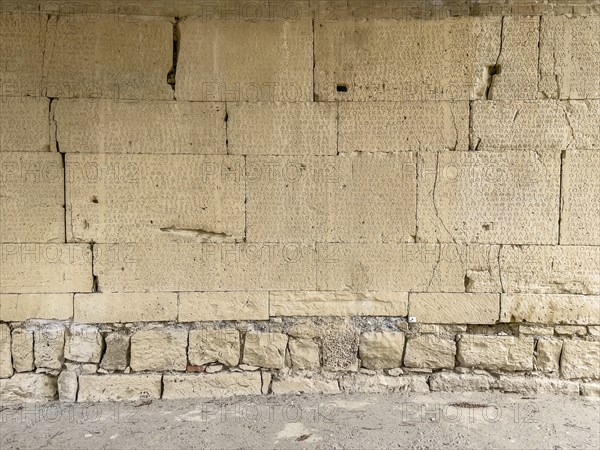 View of sandstone blocks Stones made of sandstone with written chiselled laws carved into the wall of the archway behind the amphitheatre City law of Gortys carved in stone Gortyn law book Large inscription, written in Doric dialect alternately from left to right and right to left, oldest discovered legal text in Europe, Gortyna, Crete, Greece, Europe