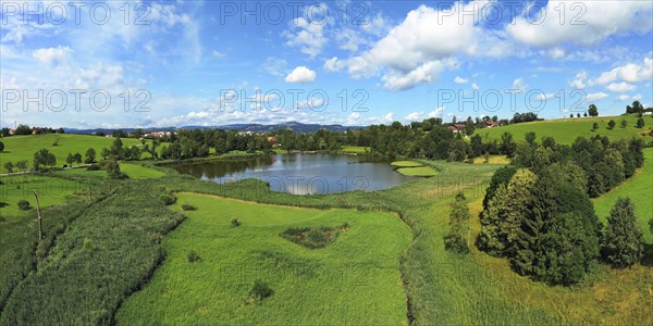 Aerial view of the Bachtelweiher near Kempten with a view of the Allgäu Alps. Sankt Mang, Kempten, Bavaria, Germany, Europe