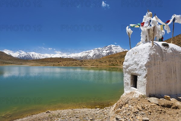 A stupa stands at the edge of a pristine mountain lake used by Buddhist pilgrims near Dhankar, Spiti Valley, Himachal Pradesh, India, Asia