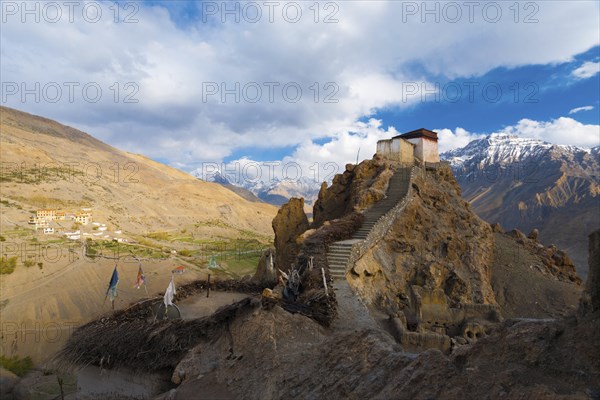 A wide view of the watchtower at the old monastery and its commanding view of the new monastery, mountains and Spiti valley below in Dhankar, Himachal Pradesh, India, Asia