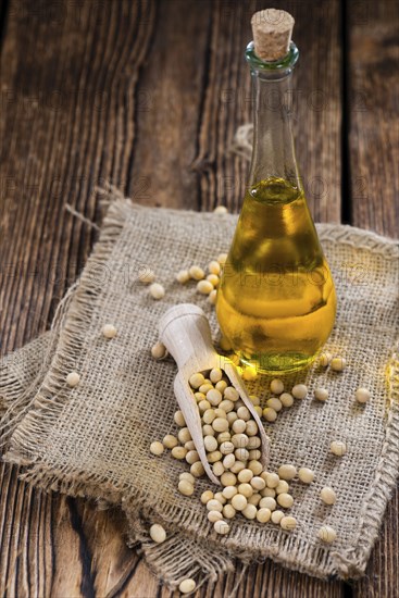 Portion of Soy Oil (close-up shot) on an old wooden table