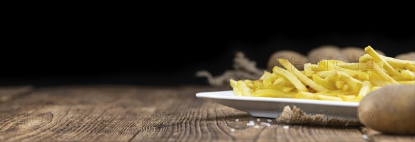 Portion of homemade French Fries (close-up shot, selective focus)