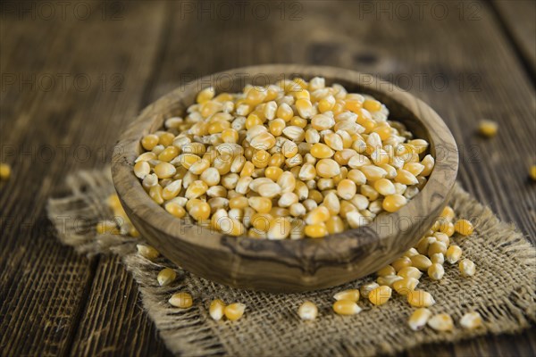 Wooden table with a portion of Corn (selective focus, close-up shot)