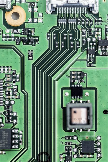 Green PCB (printed circuit board) close-up shot with a lot of electronic components