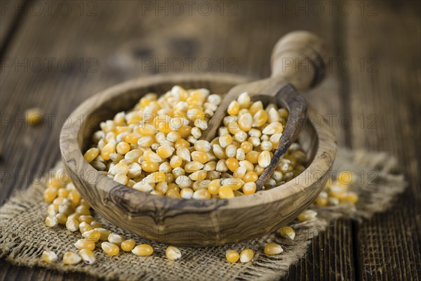 Wooden table with a portion of Corn (selective focus, close-up shot)