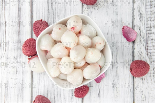 Lychees on a vintage background as detailed close-up shot (selective focus)