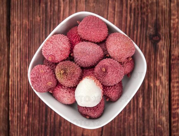 Lychees on a vintage background as detailed close-up shot (selective focus)