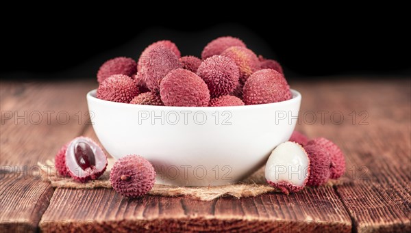 Lychees on a vintage background as detailed close-up shot (selective focus)