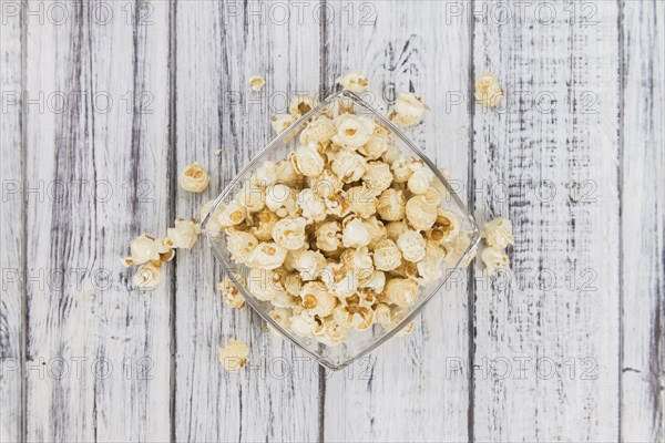 Fresh made Popcorn on a vintage background as detailed close-up shot