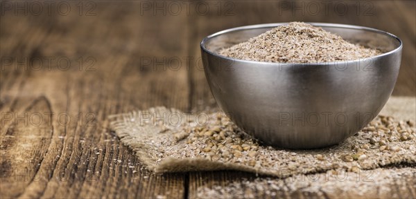 Wheat Bran on an old wooden table (selective focus)