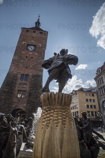 Detail of the marriage carousel, based on a poem by Hans Sachs, designed by the sculptor Jürgen Weber and built in 1984, behind it the White Tower, Nuremberg, Middle Franconia, Bavaria, Germany, Europe