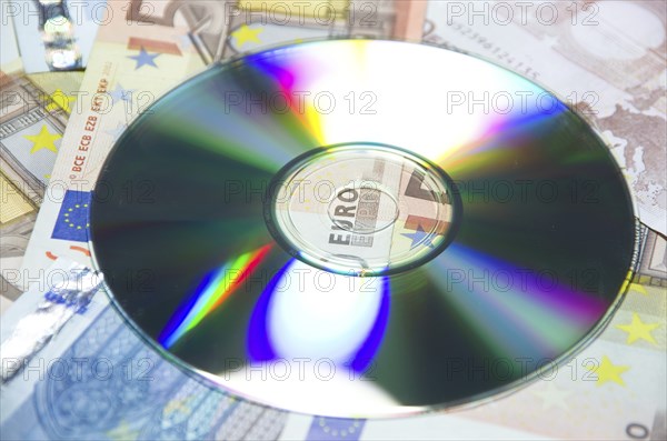 Money euro banknotes and a data cd in close up