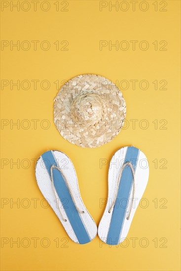 Summer vacation by the sea, flip flops and a straw hat, travel and tourism concept