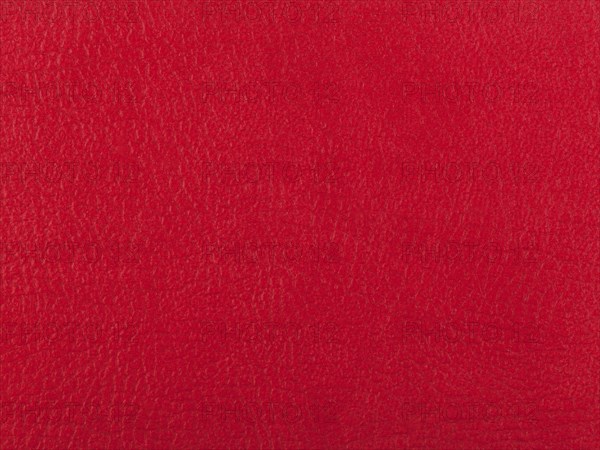 Abstract texture of synthetic leather, red background