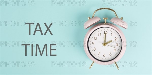 Tax time, alarm clock for taxation, deadline for payment, financial income