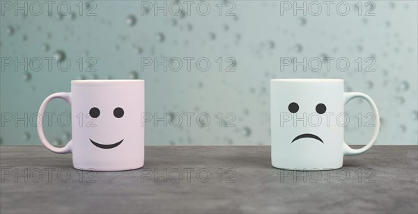 Happy and sad face, cups on a window sill, hot drink on a rainy day, relationship and friendship concept