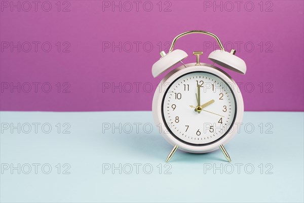 Alarm clock in old retro style, pastel color, time to wake up in the morning