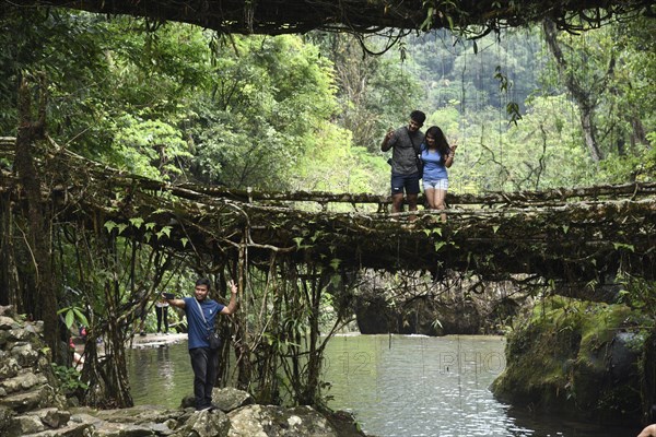 Tourists at the Bouble decker living root bridge amid COVID-19 coronavirus pandemic, in Nongriat village in Northeastern India state Meghalaya, on 19 April 2021. The living root bridges, created by the members of the Khasi tribe who have grown them from rubber trees, are native to the region. The double-decker root bridge, is the most famous one near Cherapunji