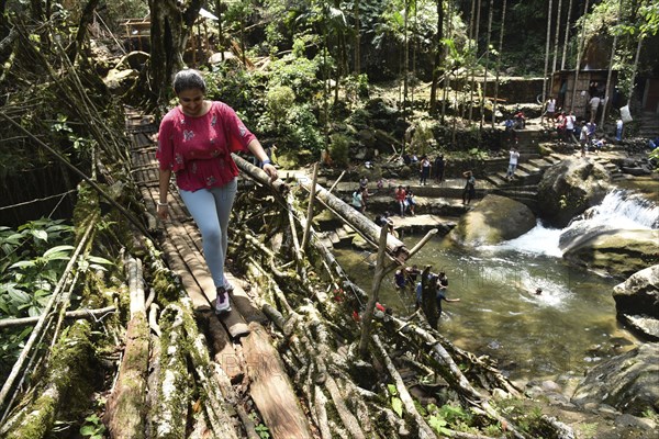 Tourists at the Bouble decker living root bridge amid COVID-19 coronavirus pandemic, in Nongriat village in Northeastern India state Meghalaya, on 19 April 2021. The living root bridges, created by the members of the Khasi tribe who have grown them from rubber trees, are native to the region. The double-decker root bridge, is the most famous one near Cherapunji