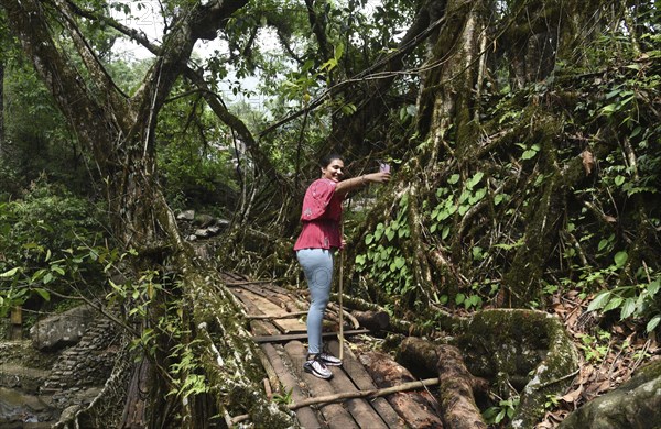 Tourists at the Bouble decker living root bridge amid COVID-19 coronavirus pandemic, in Nongriat village in Northeastern India state Meghalaya, on 19 April 2021. The living root bridges, created by the members of the Khasi tribe who have grown them from rubber trees, are native to the region. The double-decker root bridge, is the most famous one near Cherapunji