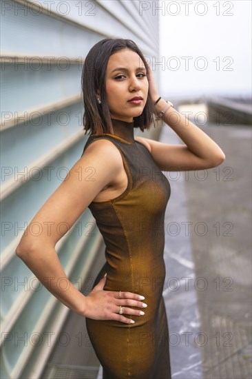 Portrait of an attractive middle eastern woman in the city. Fashion and glamor concept, looking at camera