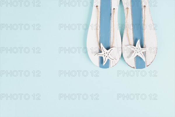 Blue colored summer and vacation background, slippers with sea stars, copy space for text, holiday and tourism concept