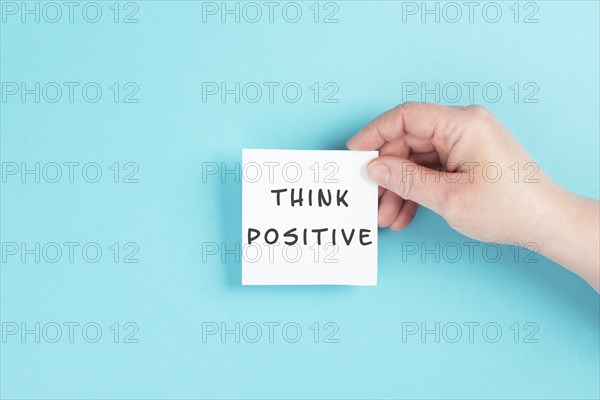 The words think positive are standing on a paper, optimistic mindset, coaching and motivation concept, attitude for success