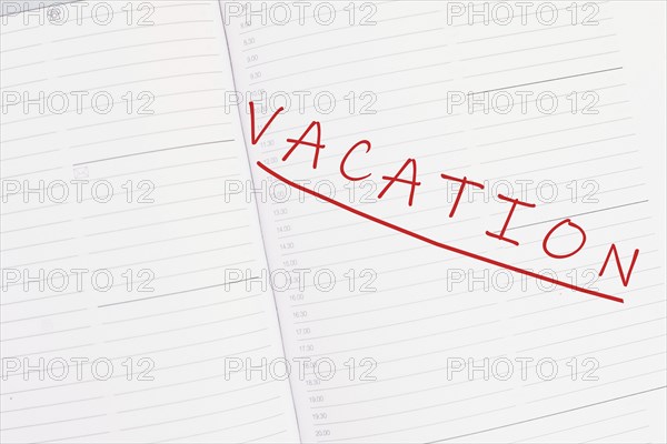 The word vacation is standing in the calendar, planning for the holiday, summer break