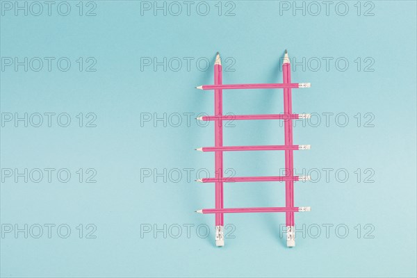 Ladder of success build with pencils, opportunity strategy, blue background, copy space for text, step by step concept, progress in business and education, have a goal