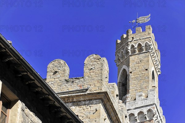 Palazzo dei Priori, City Palace, Volterra, Tuscany, Italy, Europe, A medieval castle tower under a clear blue sky with a weather vane at the top, Europe