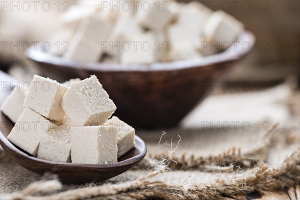 Portion of Tofu (detailed close-up shot) on wooden background