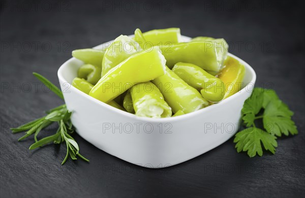 Some fresh Stuffed green Chilis on a vintage slate slab (selective focus, close-up shot)