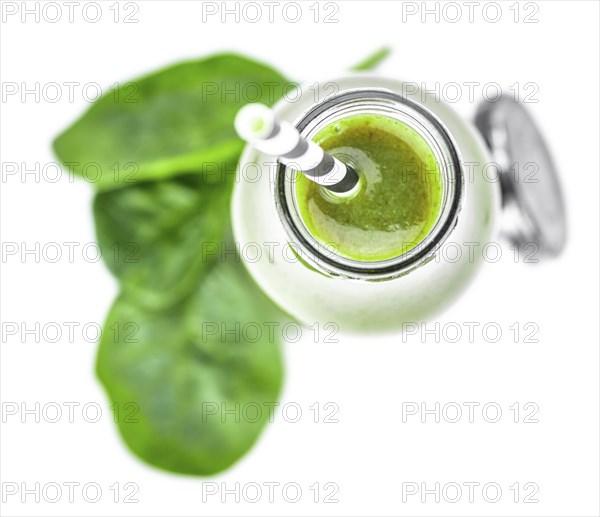 Homemade spinach smoothie isolated on white background (close up, selective focus)