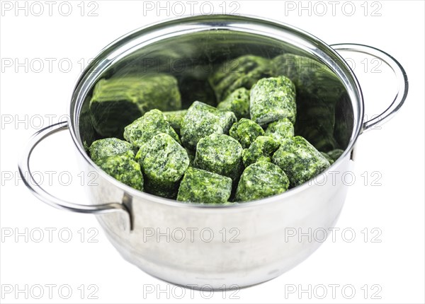 Portion of frozen spinach isolated on white background (close-up shot)