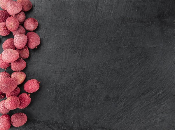 Lychees on a vintage background as detailed close-up shot (selective focus)