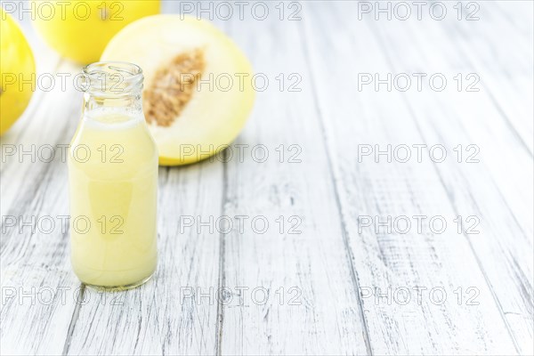 Homemade Honeydew Melon Smoothie on wooden background (selective focus)