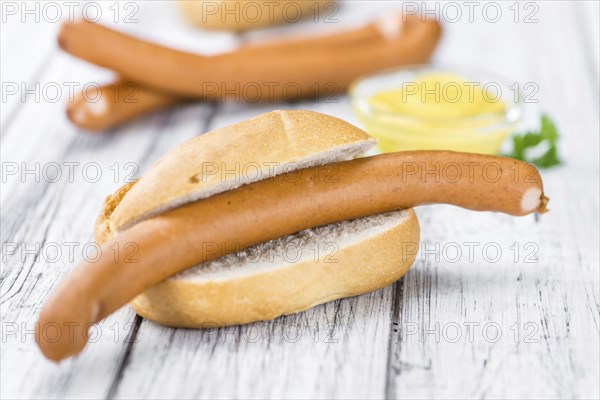 German Sausages (Wiener) as high detailed close-up shot on a vintage wooden table (selective focus)