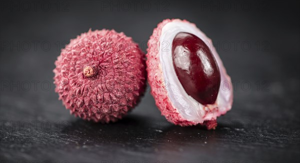 Portion of Litchis as detailed close up shot on a slate slab (selective focus)