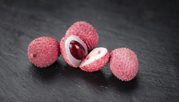 Lychees on a vintage background as detailed close-up shot (selective focus)