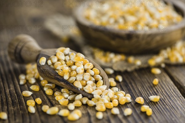 Wooden table with a portion of Corn (selective focus, close-up shot)