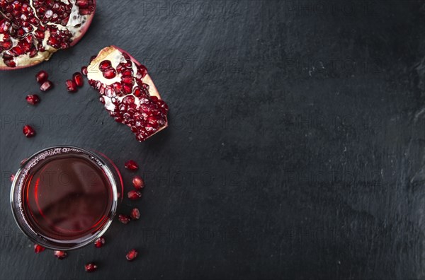 Fresh made Pomegranate juice on a vintage background (close-up shot)