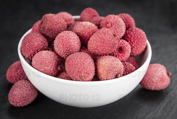 Litchis on a vintage slate slab (close-up shot, selective focus)