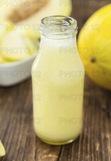 Healthy Honeydew Melon Smoothie (selective focus) on an old wooden table